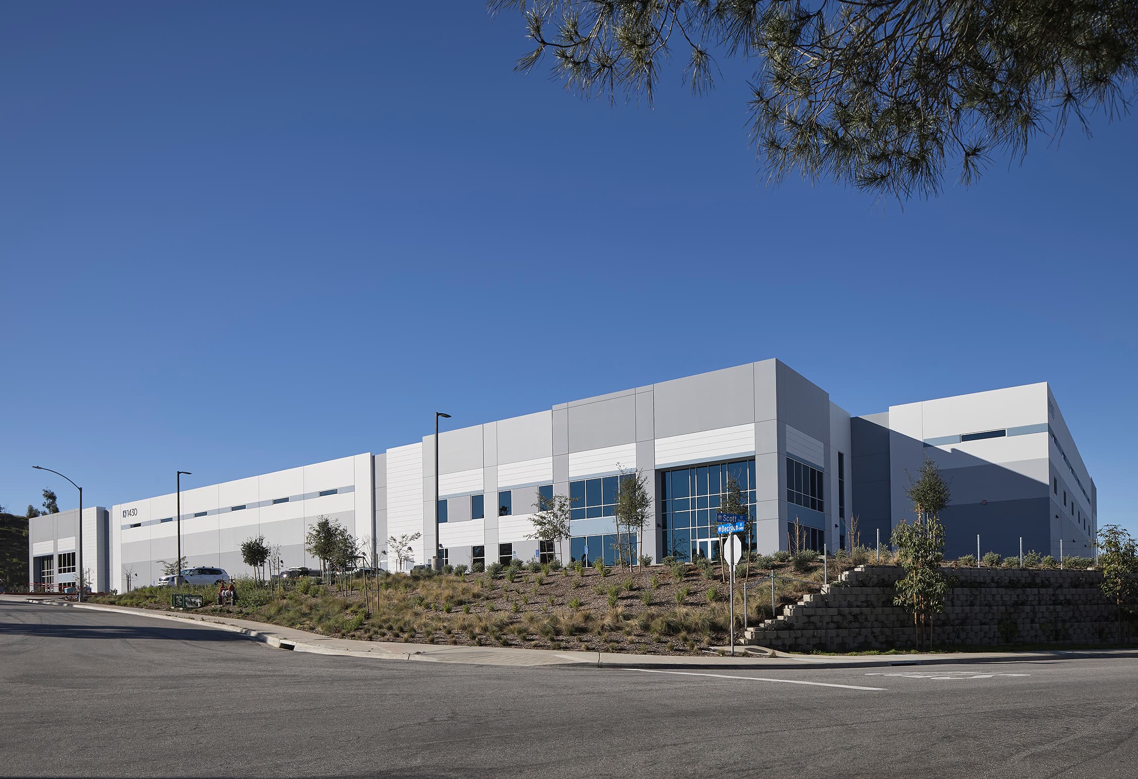 Decision Street industrial building in Vista, a white concrete tilt-up with blue glazing under a clear sky